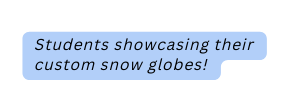 Students showcasing their custom snow globes